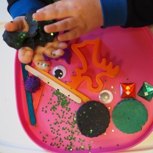 He loved this Halloween style invitation to play. Instead of giving large balls of play dough I sometimes use a pastry cutter to make it toddler sized to grab, pick up and squeeze. Really helps develop their hand muscles.
