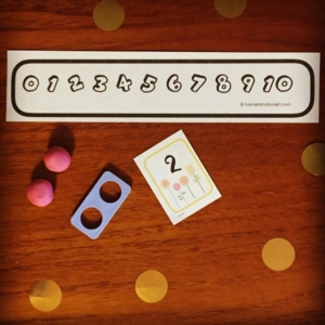 Colour your own number line, then make your own. Also in this photo is a flower number flash card, I’ve printed several on a page to make them tiny – to play maths games. All on my website link