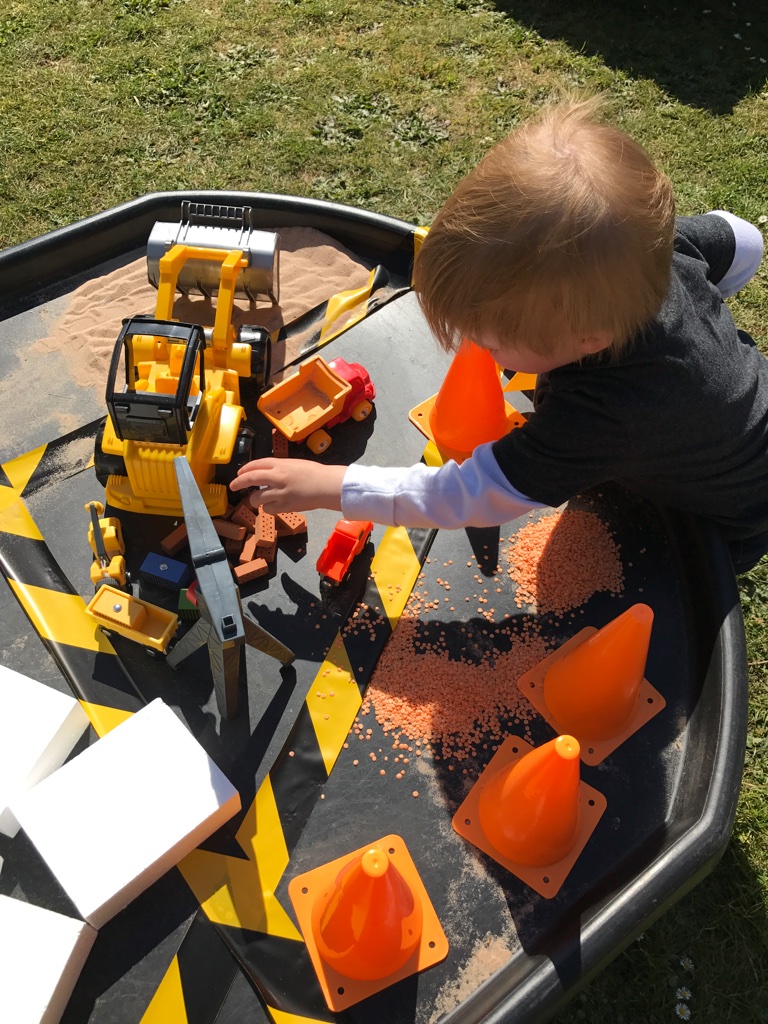 child playing construction tuff spot EYFS