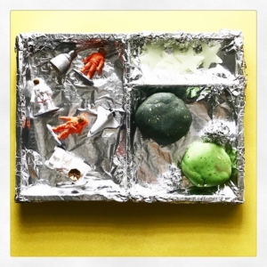 Space invitation to play  I covered a tray with foil to give a different background, re-used some play dough and dyed half black with food gel, added some small world astronauts + spaceships with a few stars.