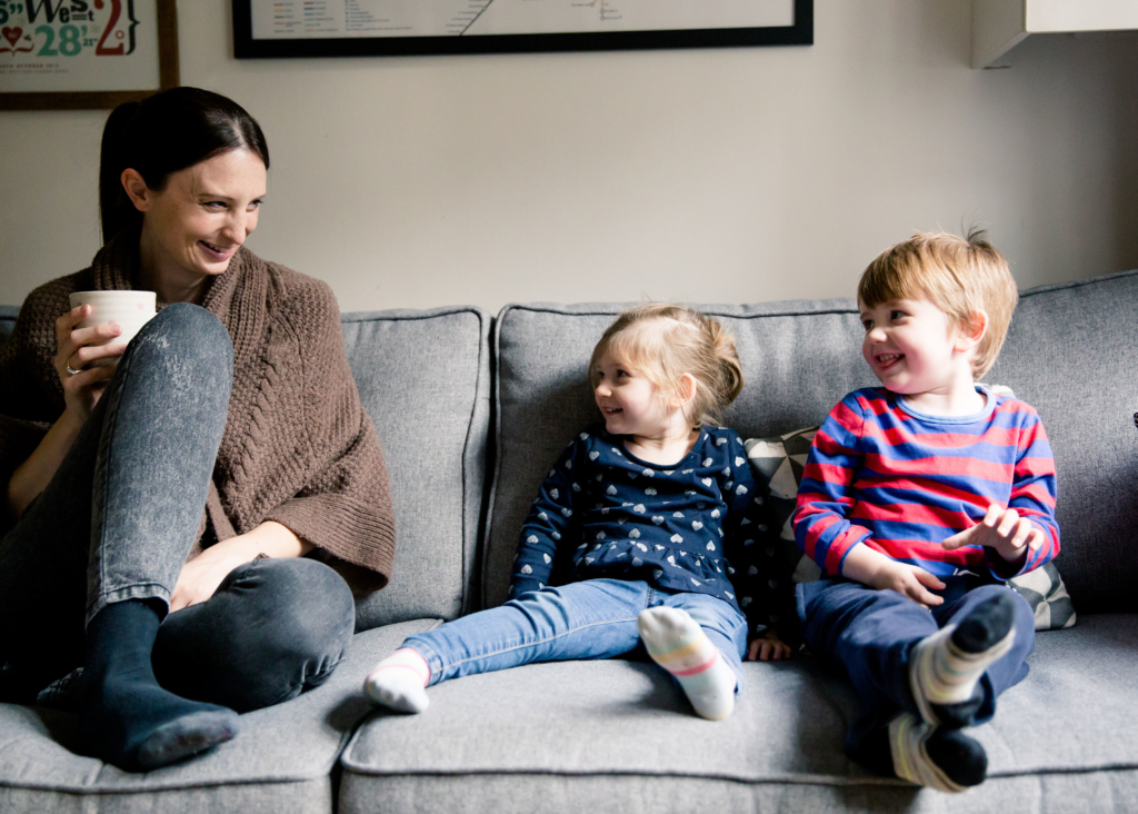 Jo Britland sat on sofa from Little Writing Company with children printplaylearn