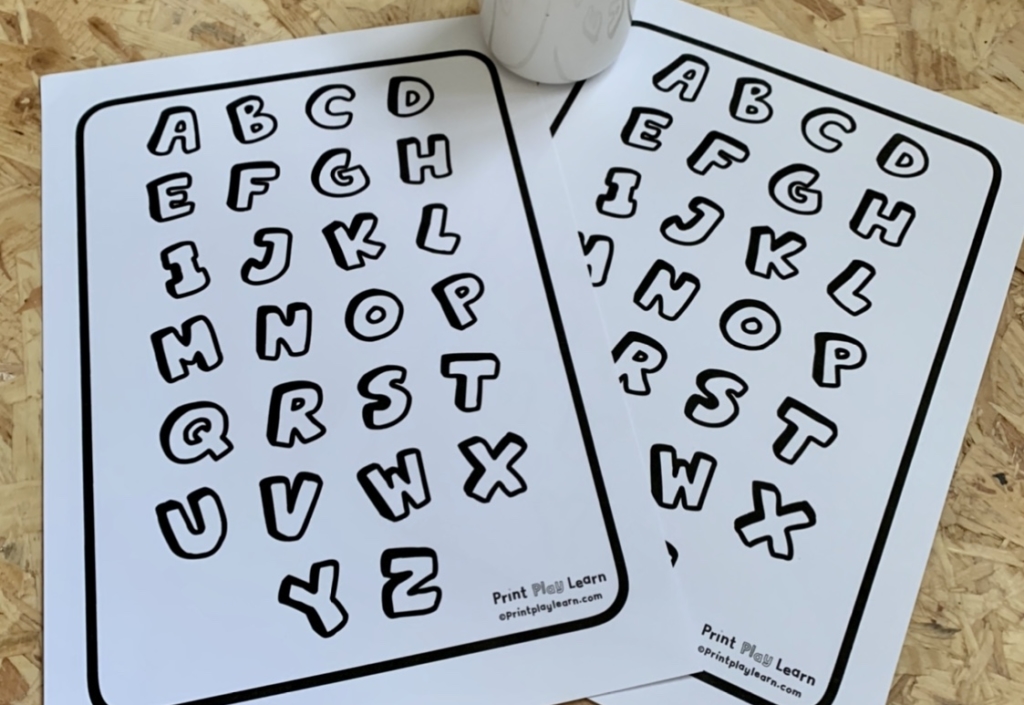 printplaylearn colour your own alphabet 10 quick activities wooden floor with 2 printed out alphabets