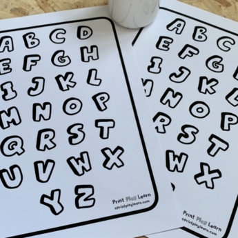 printplaylearn colour your own alphabet 10 quick activities wooden floor with 2 printed out alphabets