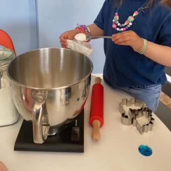 kid cooking at home to help with learning print play learn