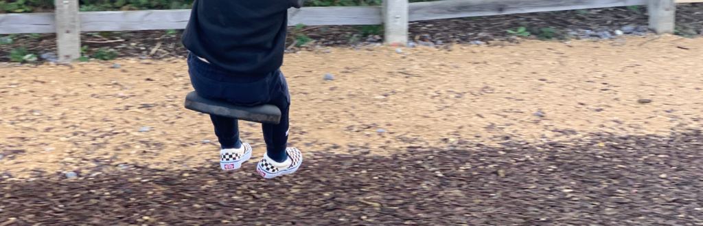 kid using gross motor skills on swing The Most Important Early Years Skills to Nurture First